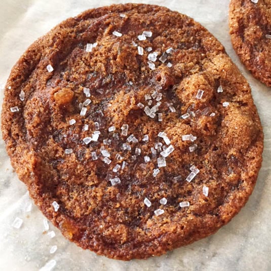 Close up of ginger bacon grease cookie sprinkled with baking sugar.