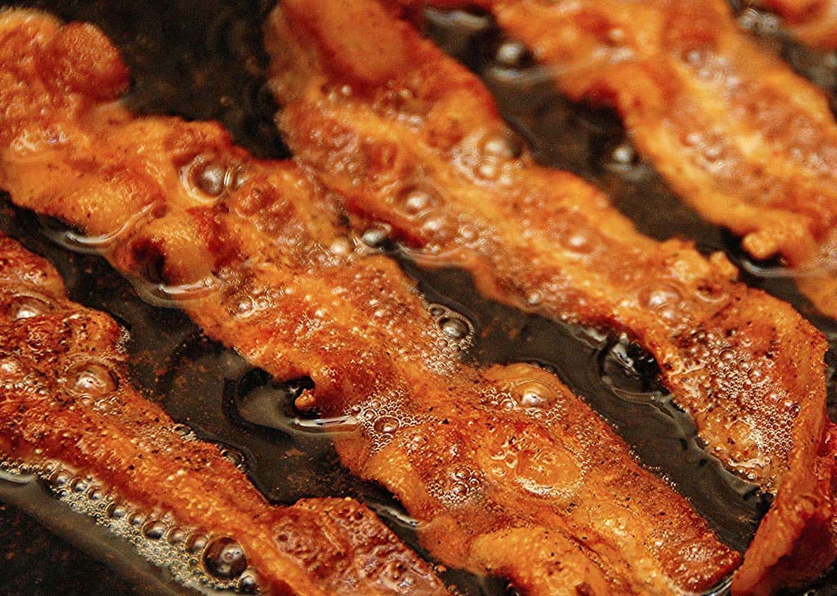 Rendering bacon fat in skillet.