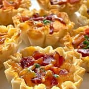 Close up of six mini quiches with bacon and cheese.