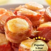 bacon wrapped scallops on a white serving dish with lemon.