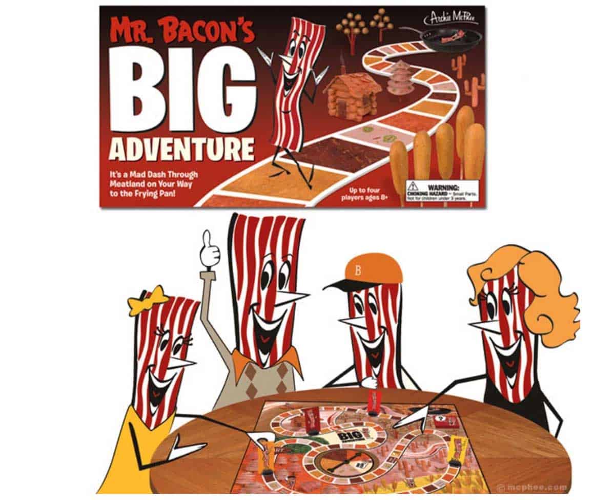 The board game Mr. Bacon's Big Adventure set up on.a card table, with the box shown at the top of the image.