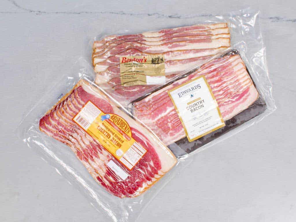 3 shrink wrapped packages of bacon.