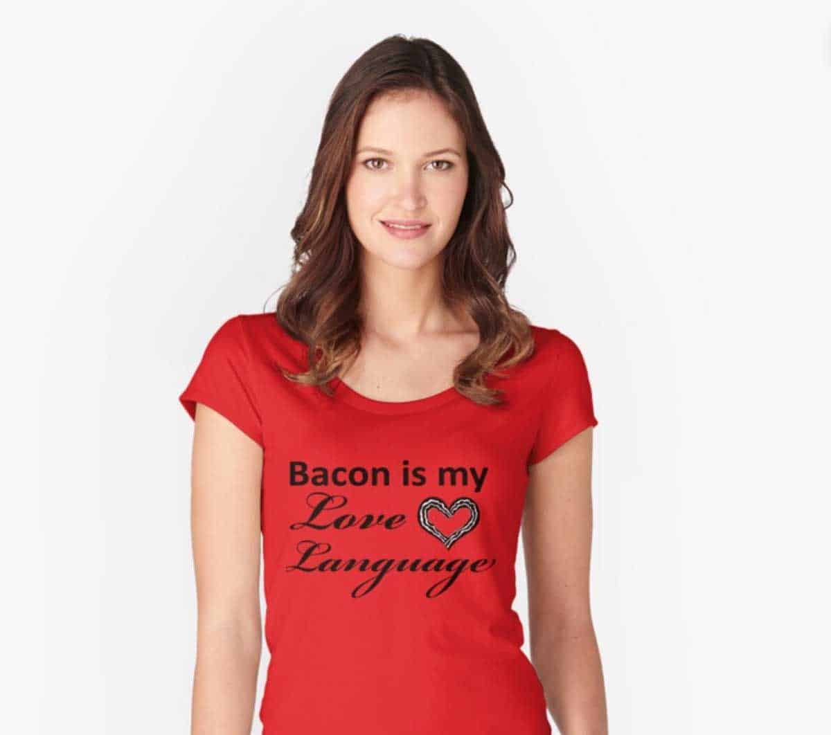 A young woman in a red t-shirt which is printed with "Bacon is my Love Language."