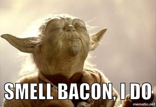 Yoda with his eyes closed facing up and text: Smell bacon, I do.