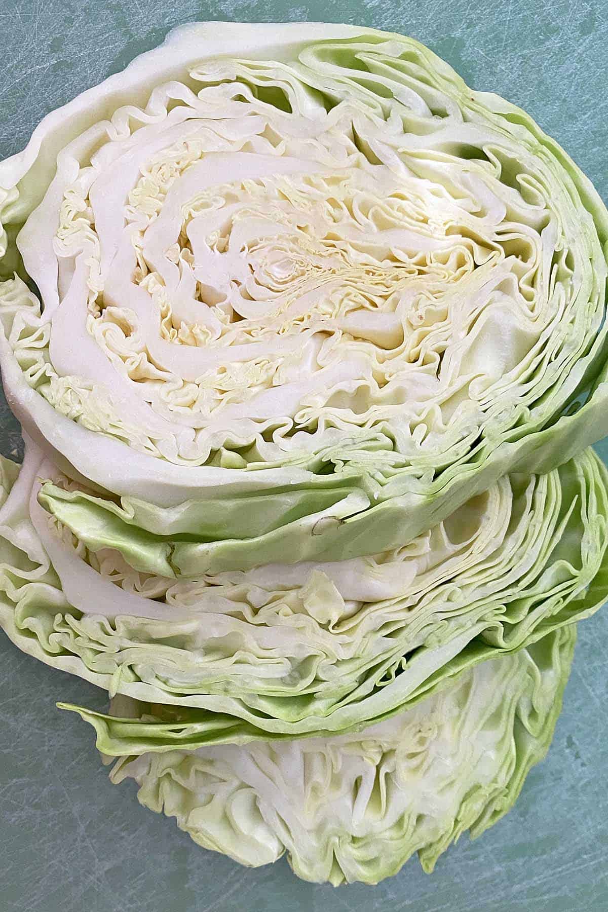 cabbage slices on a green cutting board.