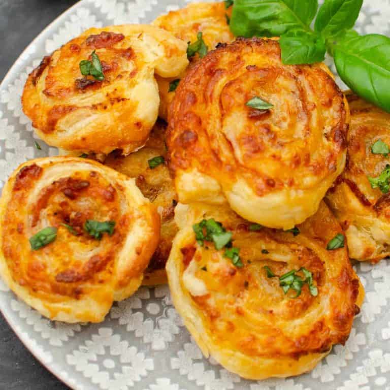 6 sundried tomato bacon swirl appetizers on a serving plate