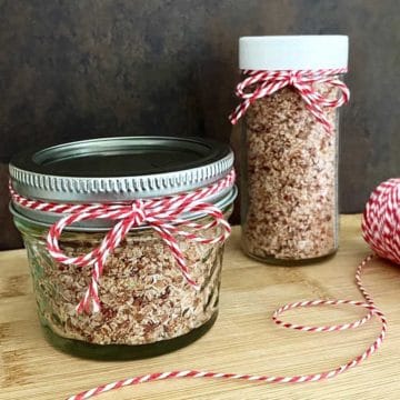 two jars of bacon salt, tied with red and white string