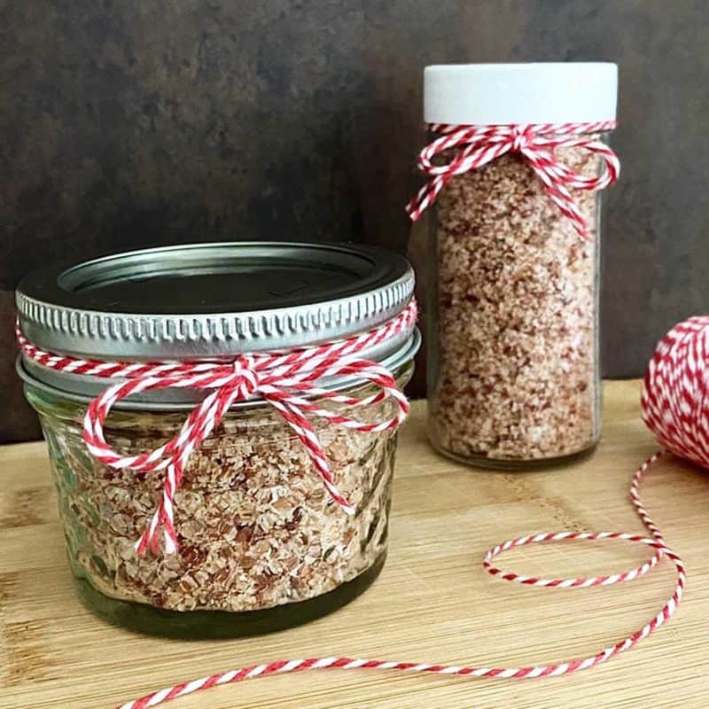 two jars of bacon salt, tied with red and white string.