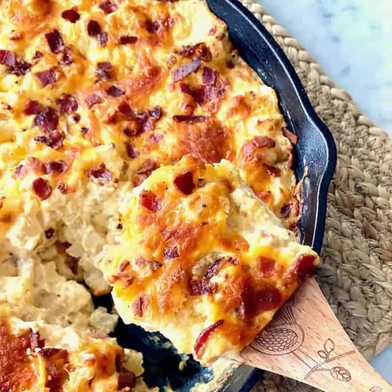 loaded potato bake in a cast iron skillet.