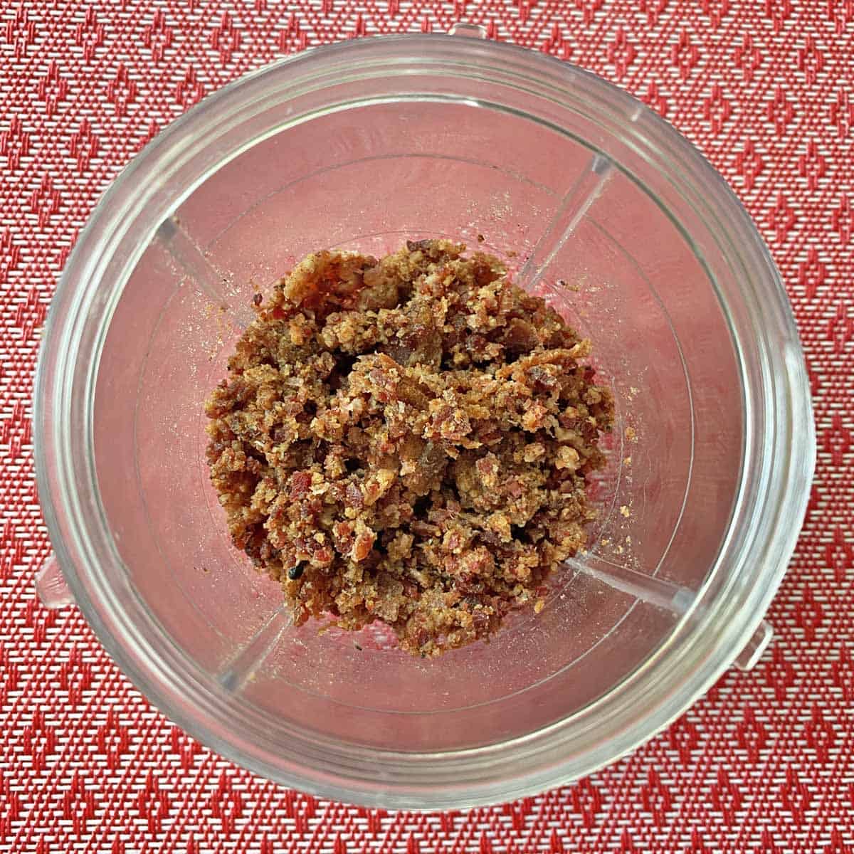 Ground cooked bacon in a blender container.