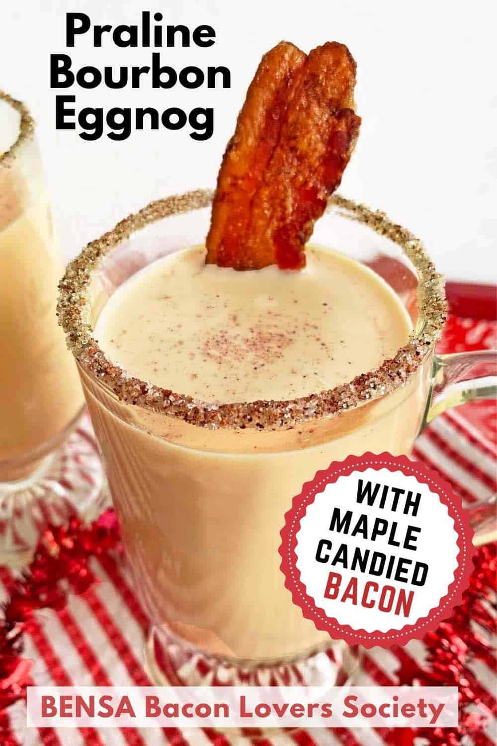 A Pinterest pin showing a mug of bourbon eggnog garnished with a strip of candied bacon