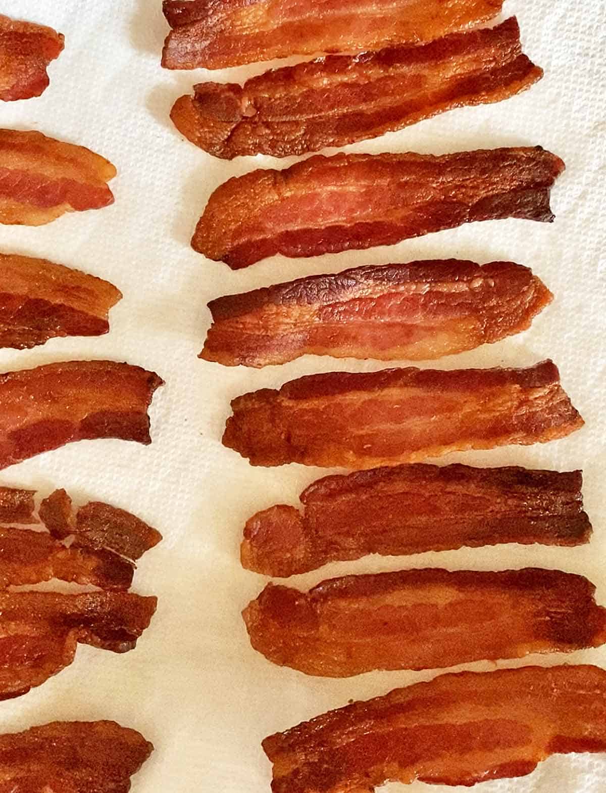 Bacon cooked in the slow cooker draining on paper towels. 