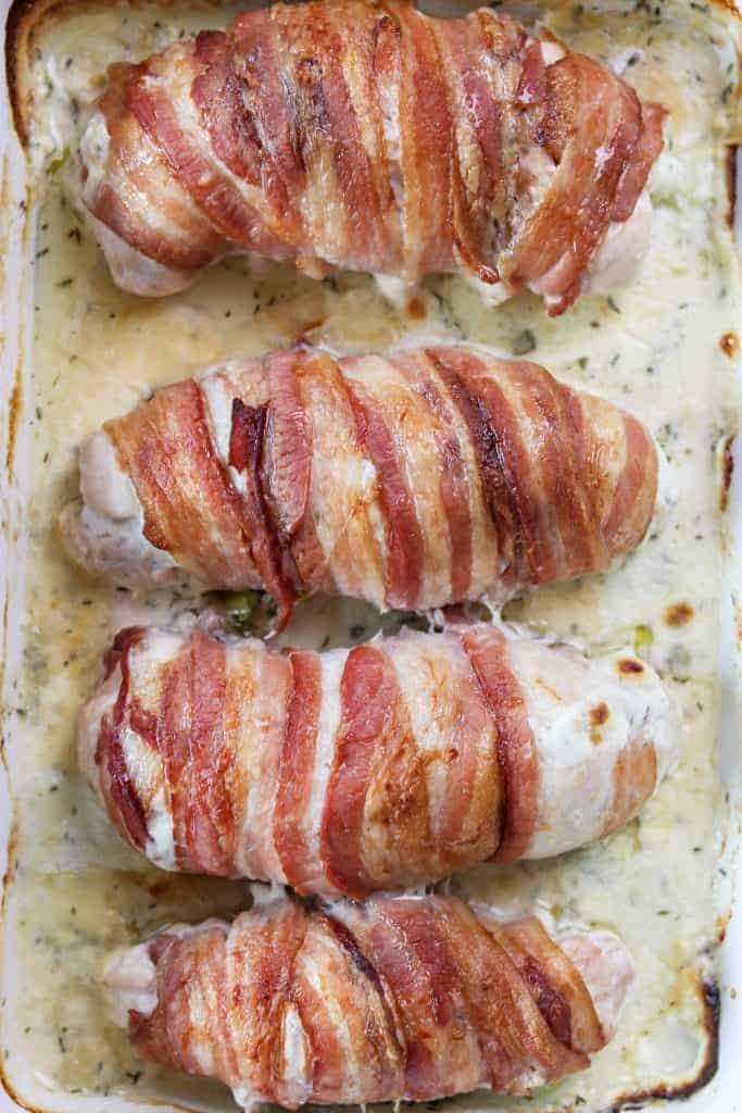Close up of bacon-wrapped cream cheese stuffed chicken breast.