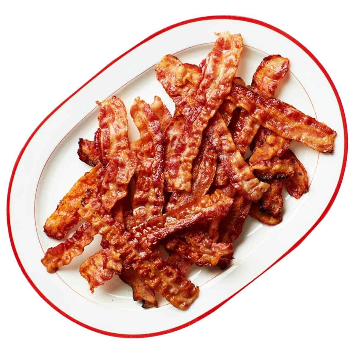 Two dozen strips of golden brown cooked reheated bacon on a white and red platter.