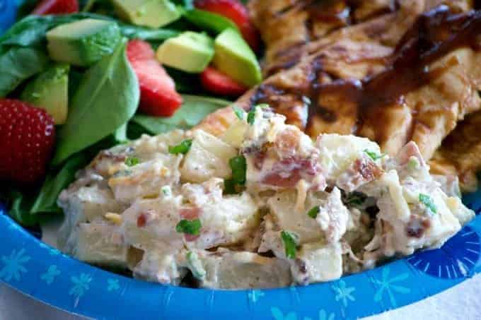 Redskin Potato Salad with bacon and creamy dressing on a blue plate.