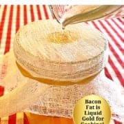 a glass measuring cup pouring bacon grease in a small jar through cheesecloth.