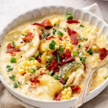 corn soup with bacon in a white bowl.