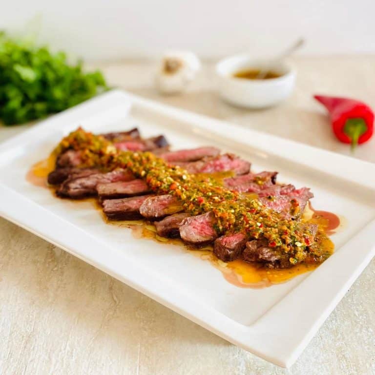 Denver steak with red chimichurri sauce.