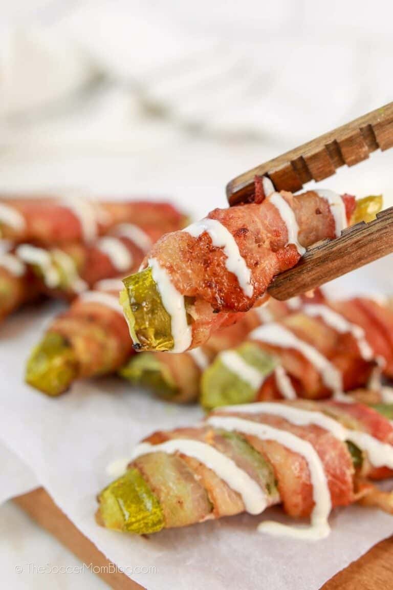 Bacon Wrapped Pickles cooked in the air fryer and arranged on a serving platter.