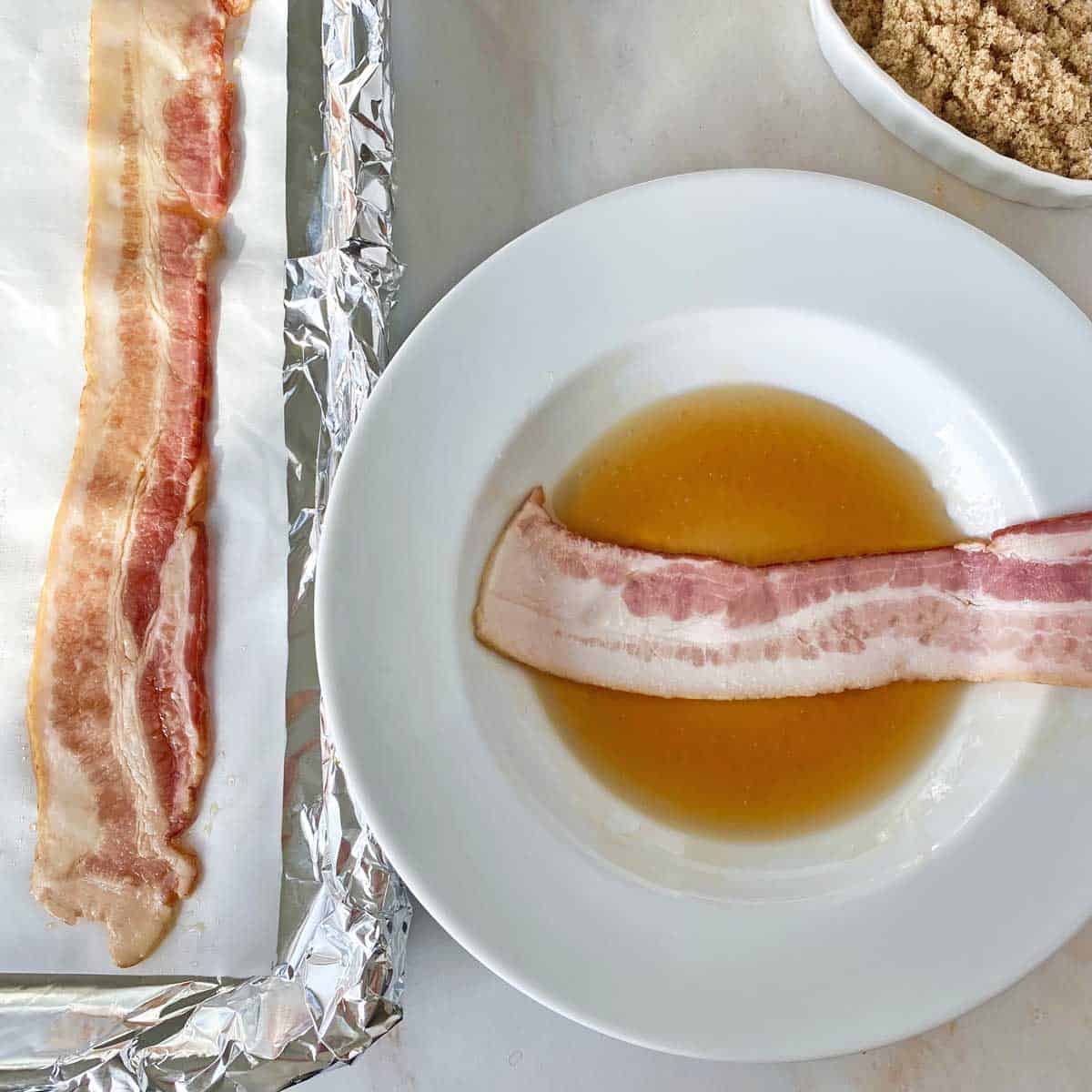 Dipping a bacon strip in maple syrup in a white bowl.