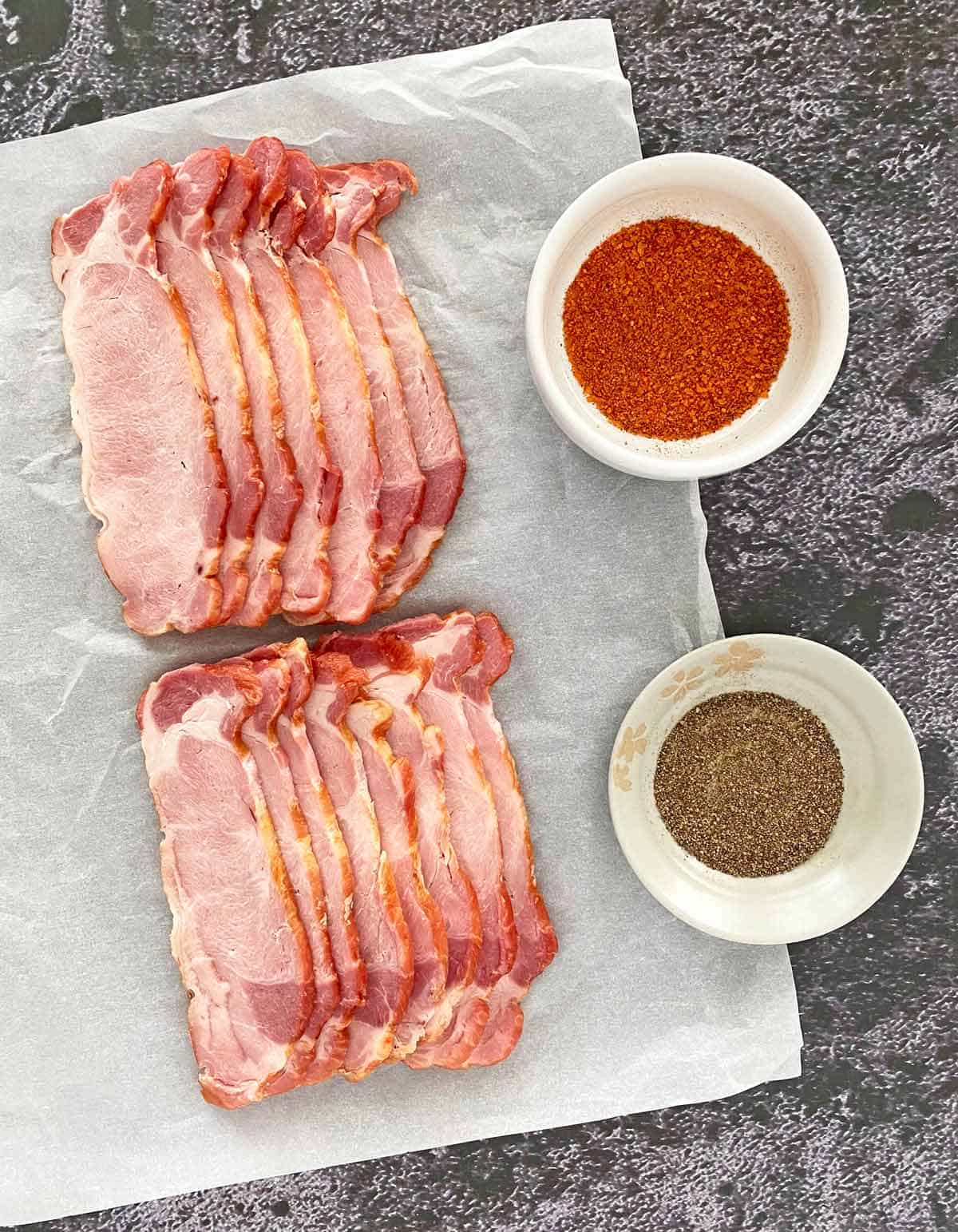 15 slices of back bacon, a small dish of freshly ground black pepper and pork spice rub seasoning.