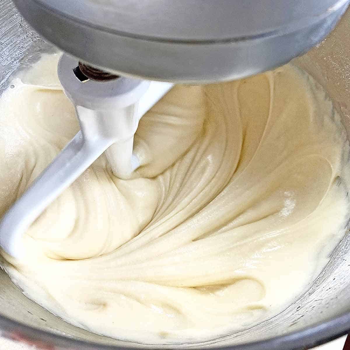 Close up of vanilla buttercream frosting in the bowl of a Kitchenaid mixer.