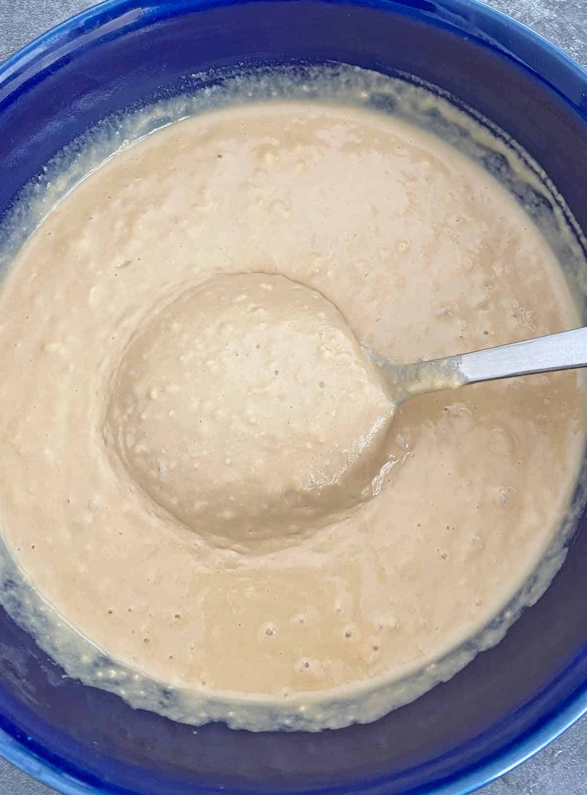 Pancake batter in a blue bowl, just after combining ingredients.