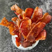 Cracked bacon strips arranged in a cup for serving.