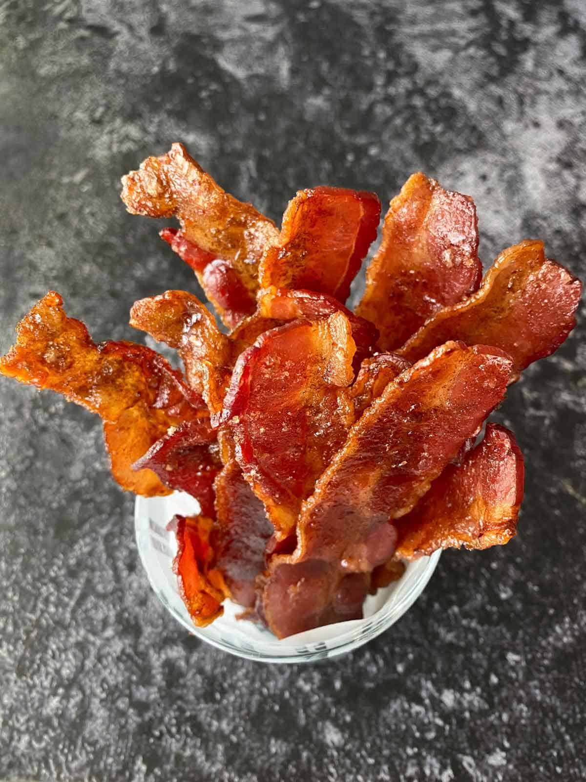 Cracked bacon strips arranged in a cup for serving.