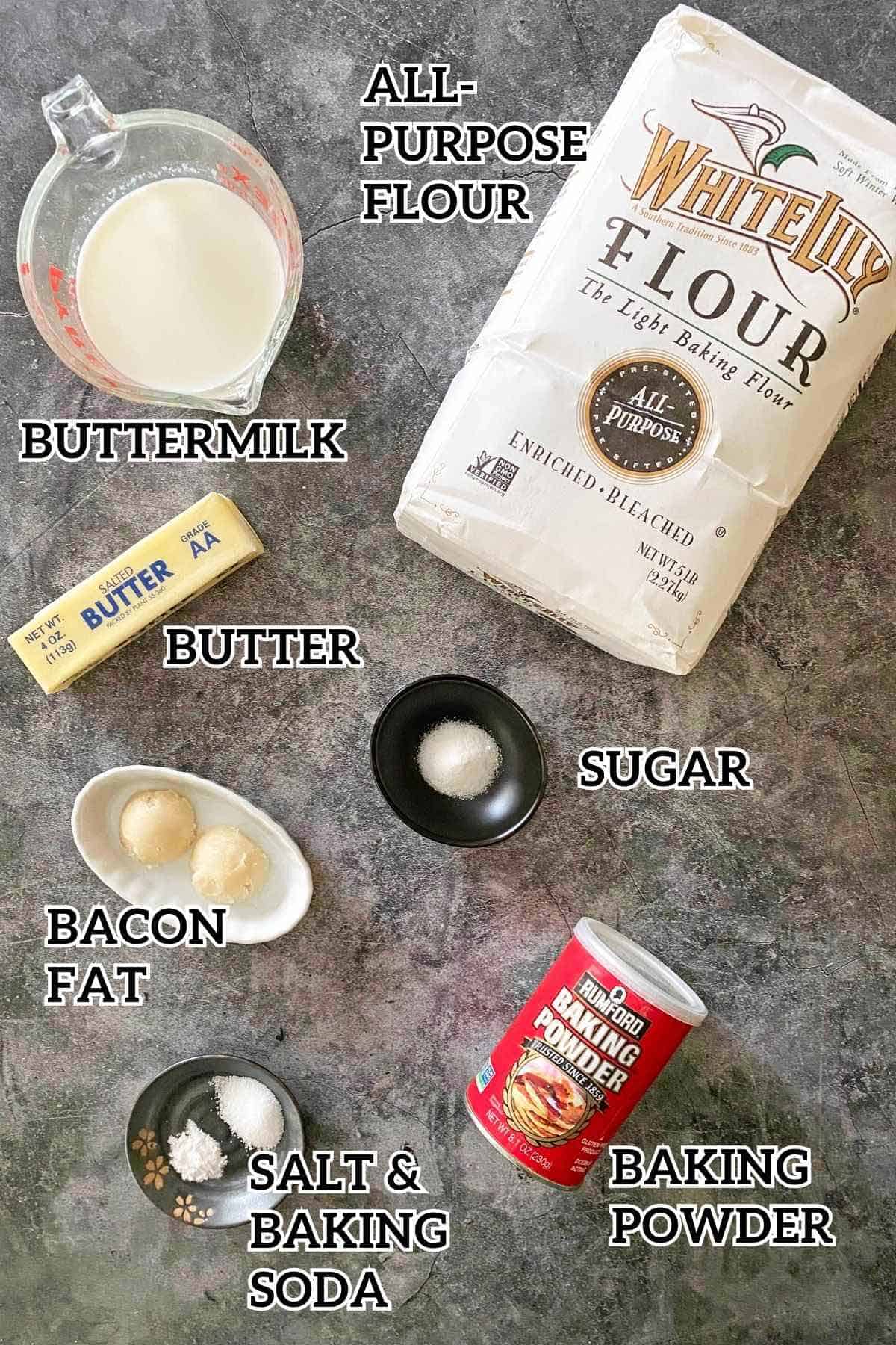 A bag of flour, buttermilk, butter, baking powder, bacon grease and other ingredients to make homemade bacon grease biscuits.