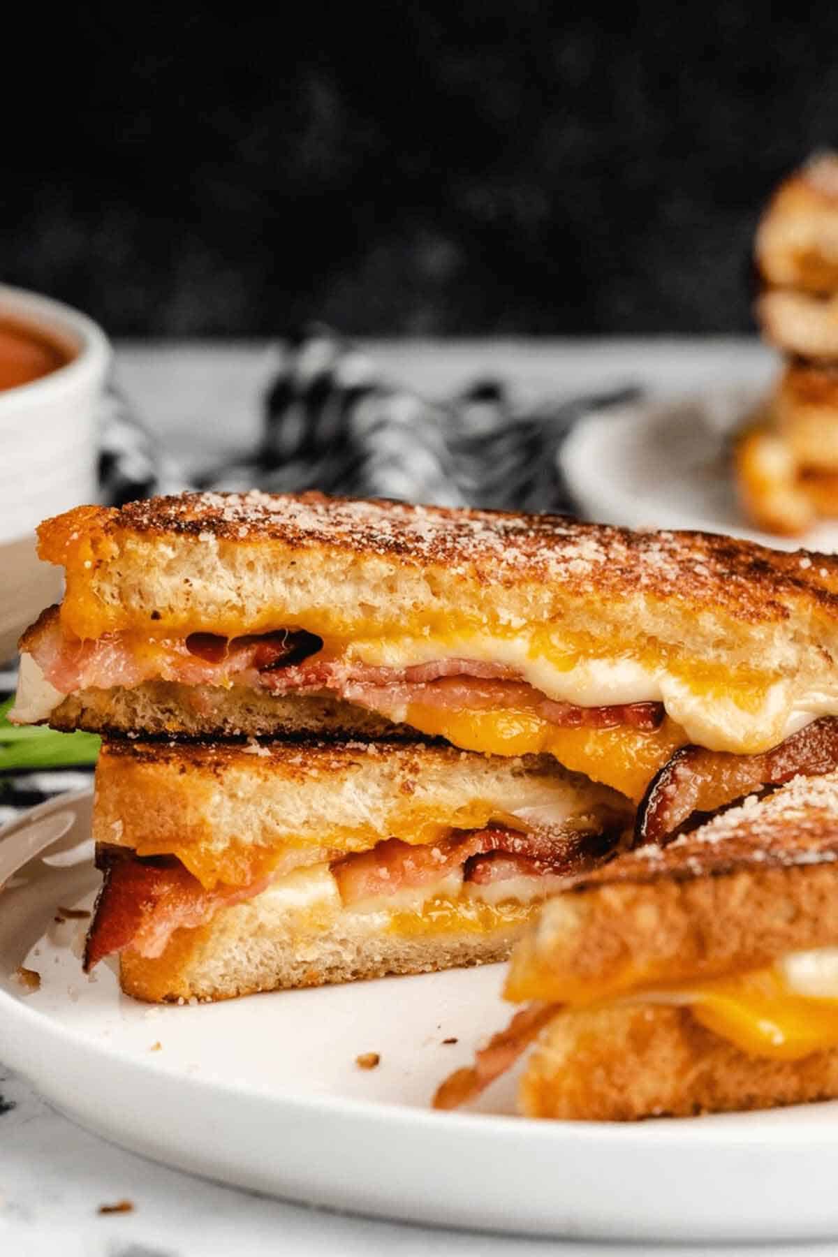 A golden brown, crispy bacon grilled cheese sandwich.