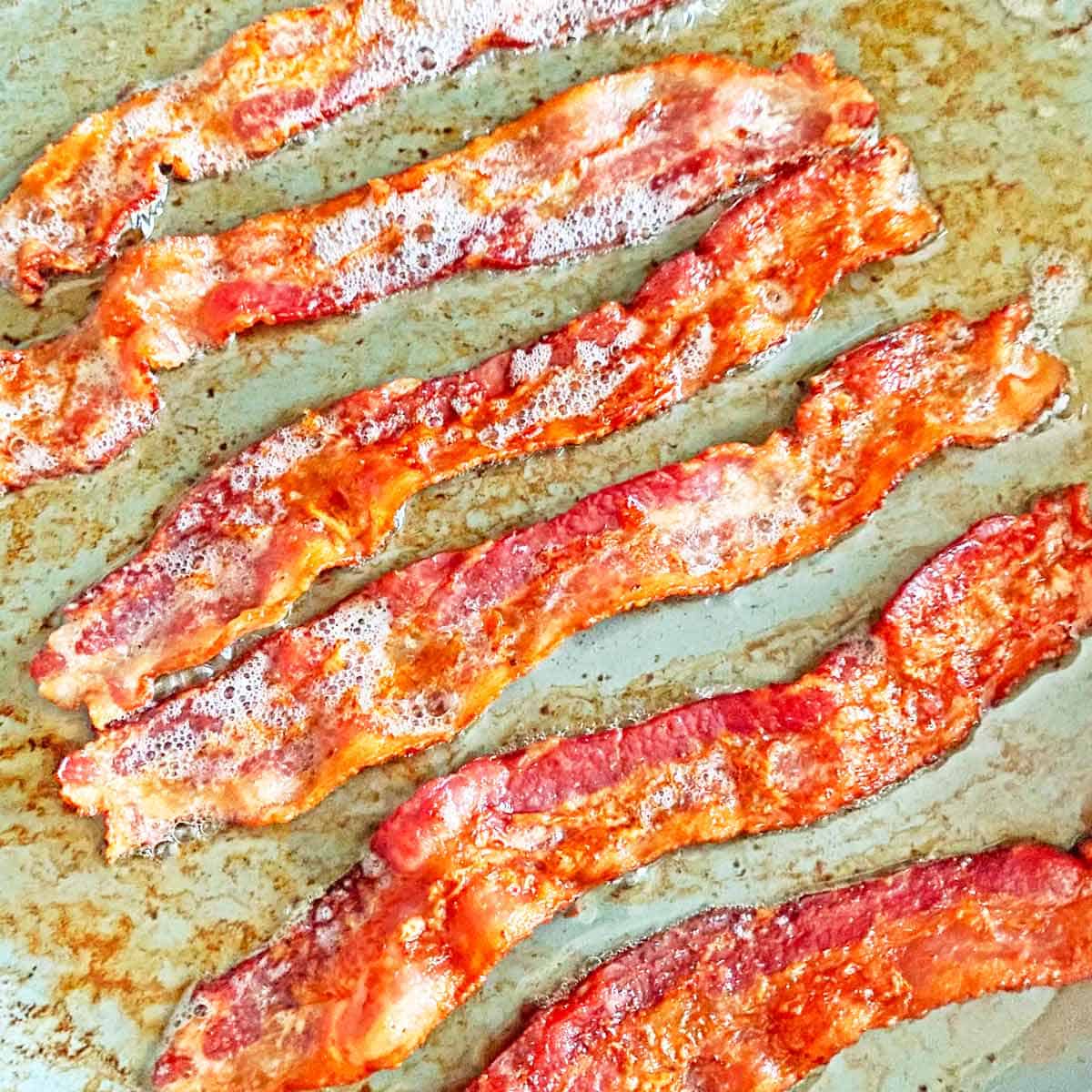 Six strips of bacon in a nonstick skillet.