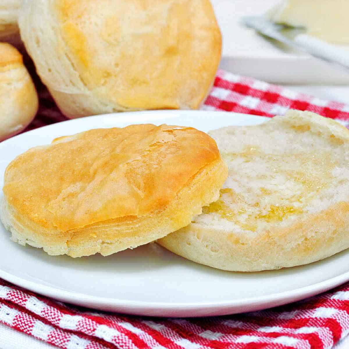 A warm biscuit cut in half and spread with butter.