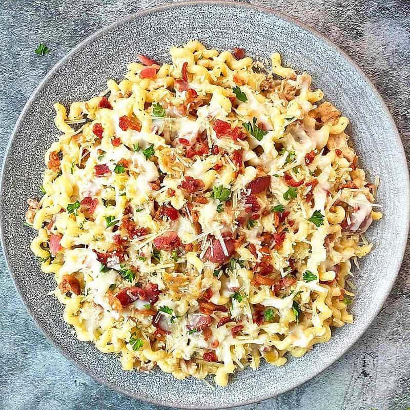 A single serving of Chicken and Pasta with Bacon, Garlic and Parmesan Cheese sauce.