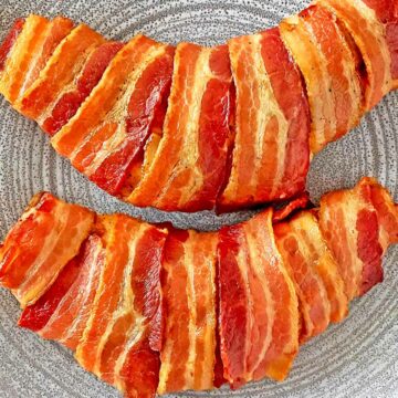 Two turkey tenderloins wrapped in bacon and cooked until golden brown.