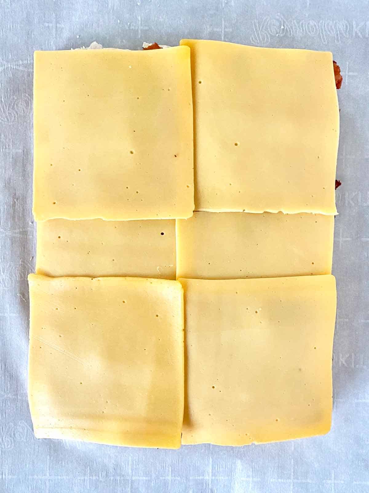 Cheese slices layered on the sliders.