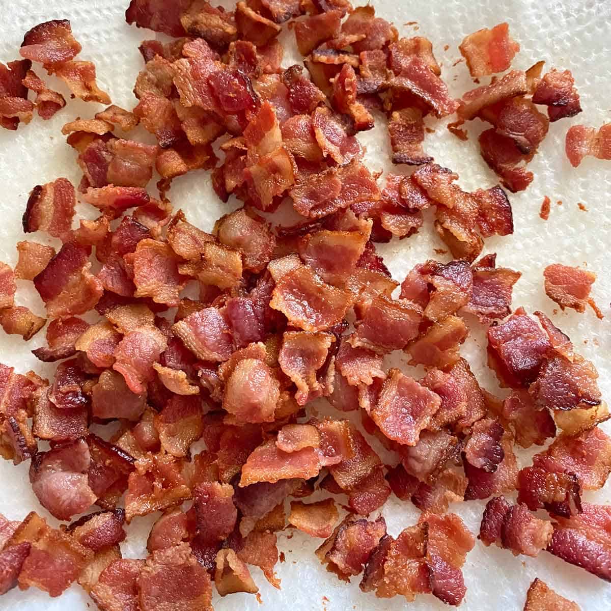 Homemade bacon bits on a white paper towel.