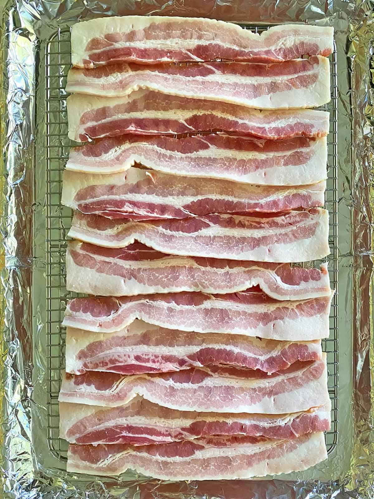 12 strips of bacon on an oven cooking rack.