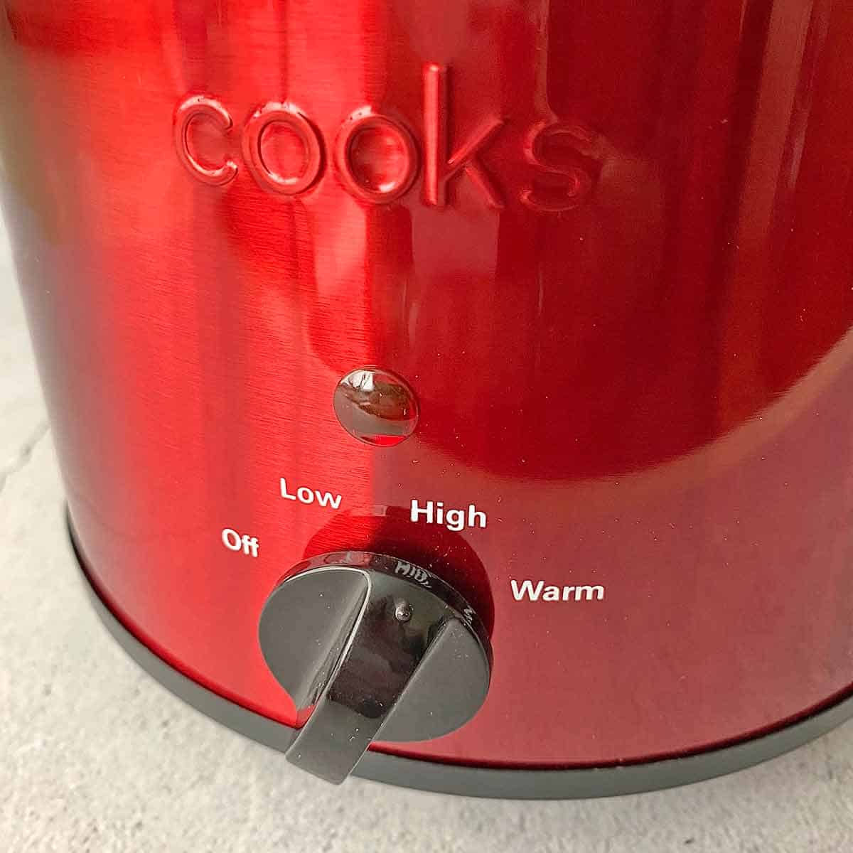 Setting the crock pot temperature to high.