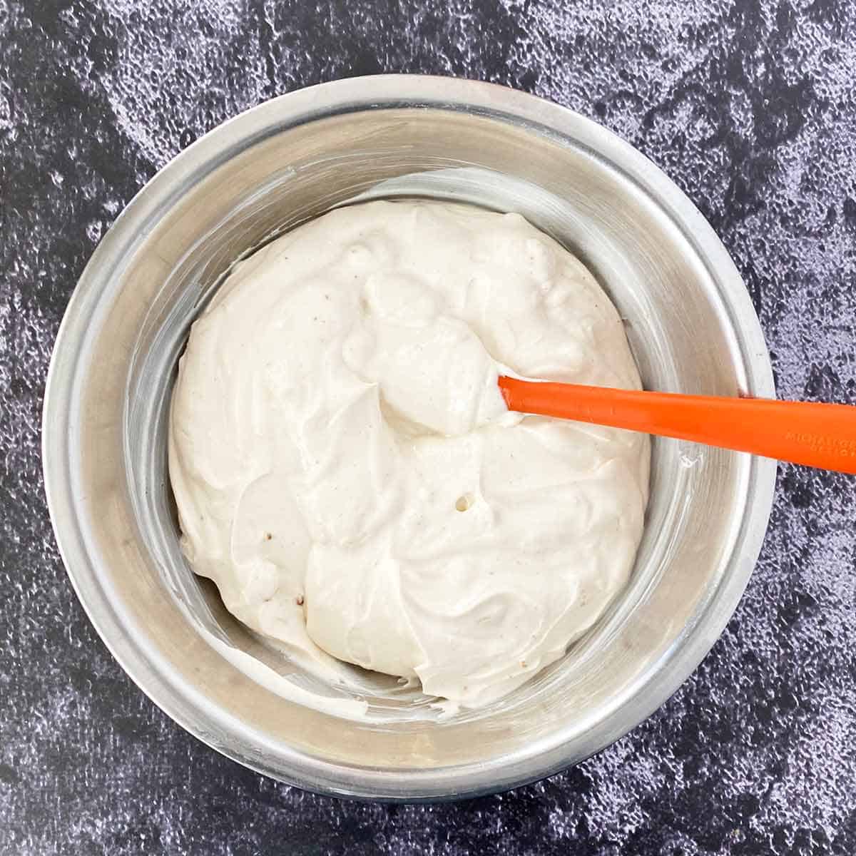 Combining the sour cream and horseradish sauce in a mixing bowl.