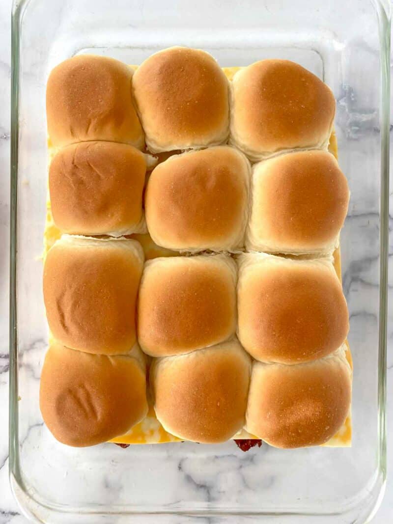The top buns placed on the sliders.
