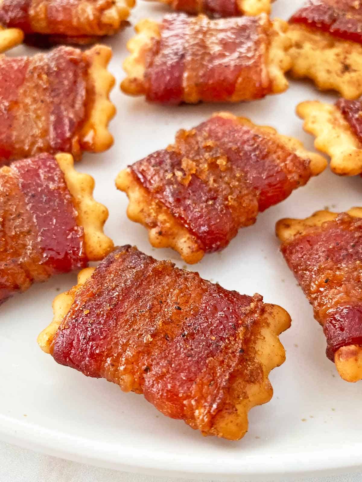 Close up of brown sugar glazed bacon wrapped Chicken in a Biskit crackers.